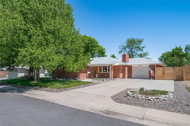 ranch-style home with a front yard and a garage