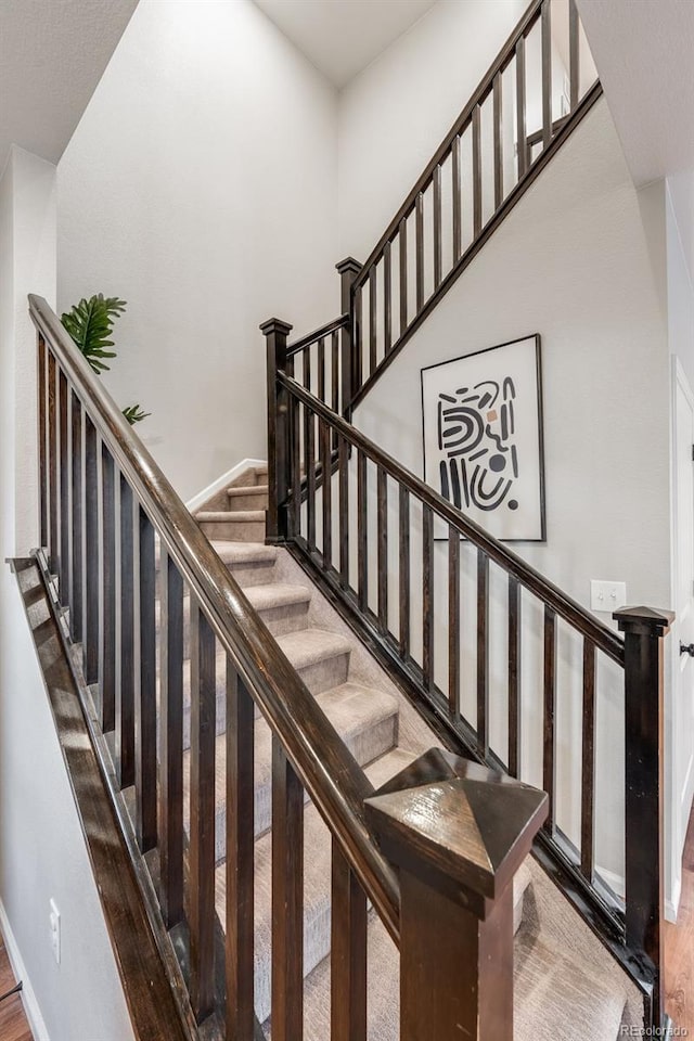 stairway featuring wood-type flooring