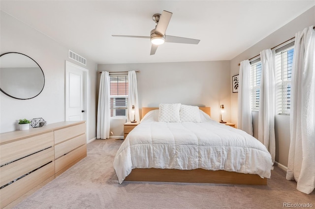 bedroom with ceiling fan and light carpet