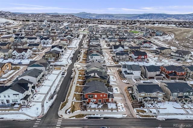 snowy aerial view with a mountain view