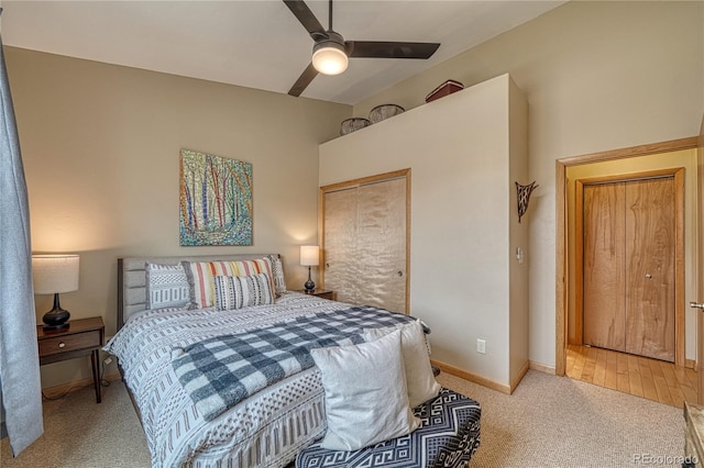 bedroom with lofted ceiling, carpet flooring, baseboards, and ceiling fan