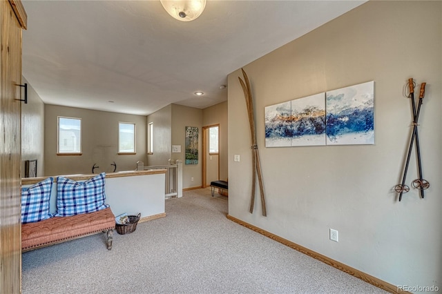 sitting room with carpet flooring and baseboards