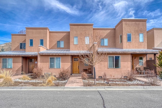 view of property featuring crawl space and stucco siding