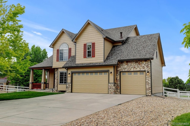 1864 Malibu Ct, Fort Lupton, CO 80621 - view of front of home featuring stone siding, concrete driveway, roof with shingles, and covered porch
