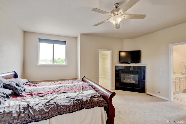 1864 Malibu Ct, Fort Lupton, CO 80621 - carpeted bedroom with ensuite bath, a tile fireplace, baseboards, and ceiling fan