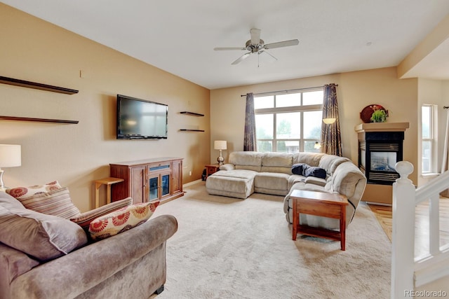 1864 Malibu Ct, Fort Lupton, CO 80621 - carpeted living room with a glass covered fireplace and a ceiling fan