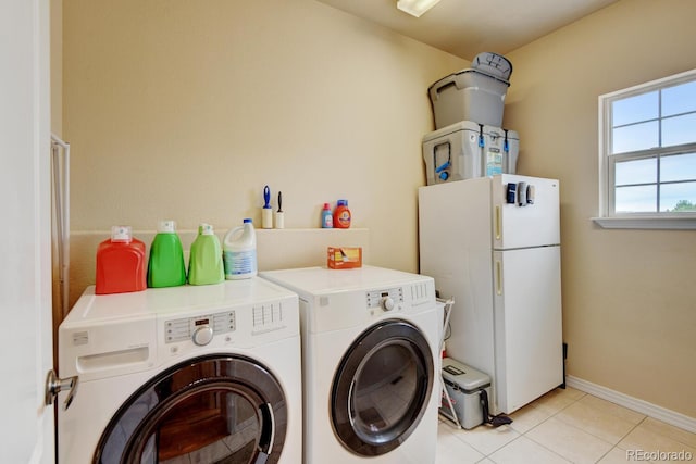 1864 Malibu Ct, Fort Lupton, CO 80621 - washroom with washer and dryer, light tile patterned floors, and baseboards