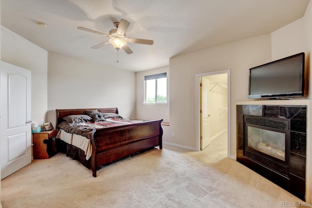 1864 Malibu Ct, Fort Lupton, CO 80621 - bedroom featuring light colored carpet, a fireplace, baseboards, a ceiling fan, and ensuite bath