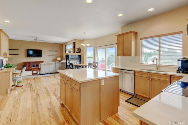 1864 Malibu Ct, Fort Lupton, CO 80621 - kitchen featuring stainless steel dishwasher, a sink, light wood-style flooring, a center island, and light countertops
