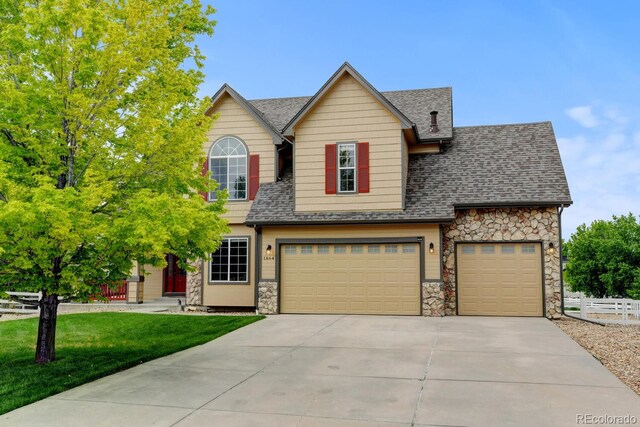 1864 Malibu Ct, Fort Lupton, CO 80621 - view of front of home featuring stone siding, concrete driveway, and a shingled roof