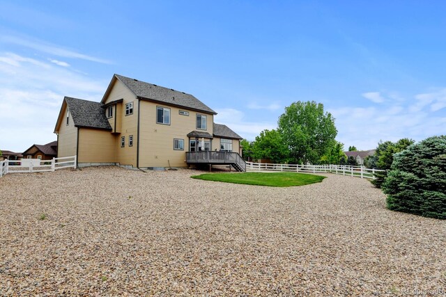 1864 Malibu Ct, Fort Lupton, CO 80621 - back of house featuring a fenced backyard, a wooden deck, and a shingled roof