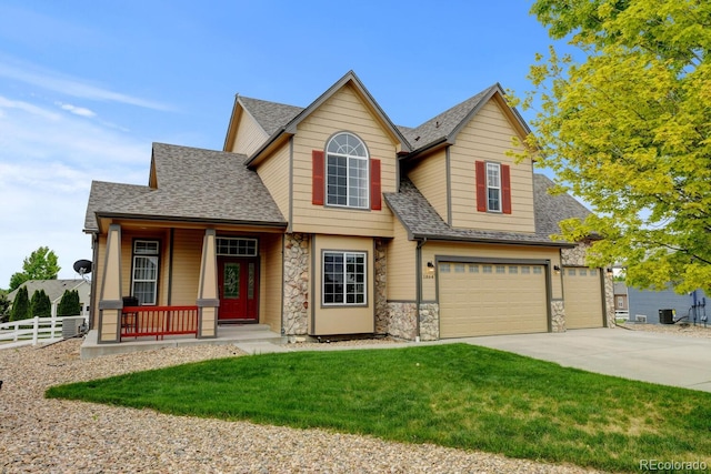 1864 Malibu Ct, Fort Lupton, CO 80621 - view of front of home featuring stone siding, a porch, driveway, a shingled roof, and a garage