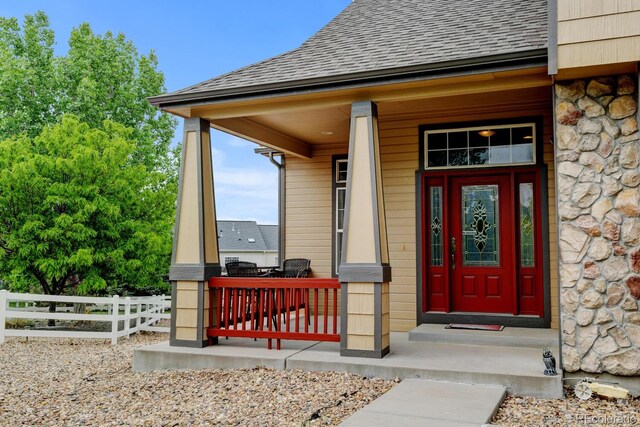 1864 Malibu Ct, Fort Lupton, CO 80621 - doorway to property with stone siding and a shingled roof