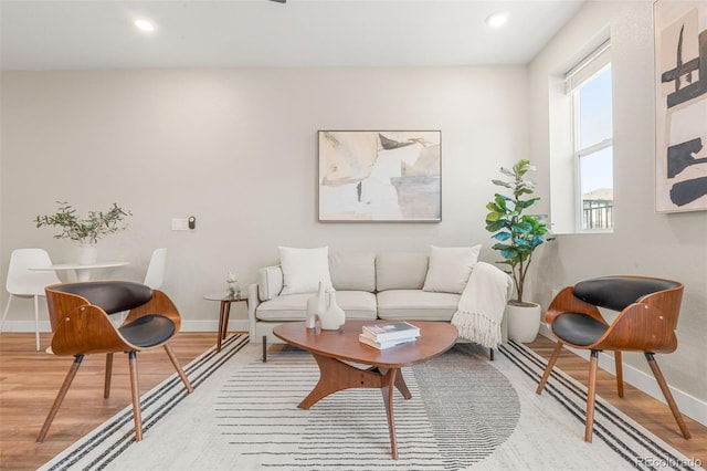 living room featuring recessed lighting, wood finished floors, and baseboards