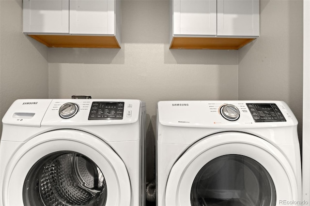 laundry room featuring washer and dryer and cabinet space