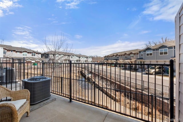 balcony with a residential view and central AC unit