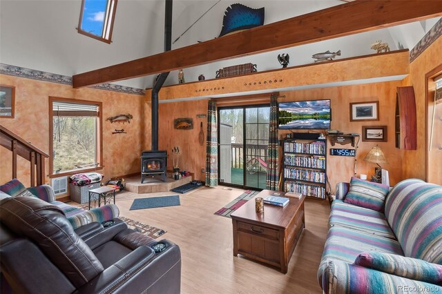 584 Old Squaw Rd, Como, CO 80432 - living area with a wood stove, wood finished floors, a high ceiling, and wooden walls