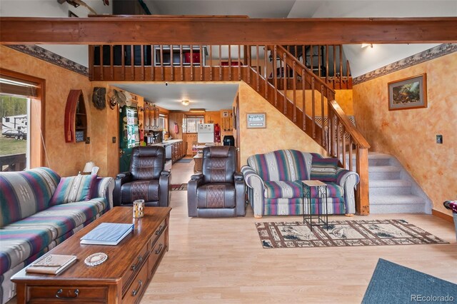 584 Old Squaw Rd, Como, CO 80432 - living area featuring light wood-style flooring, stairs, and beam ceiling