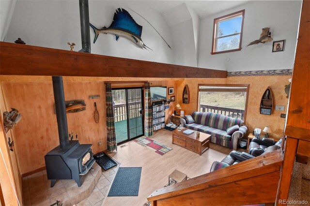 584 Old Squaw Rd, Como, CO 80432 - living area featuring a towering ceiling, a wood stove, and healthy amount of natural light