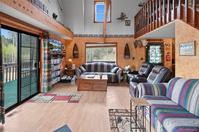 584 Old Squaw Rd, Como, CO 80432 - living room featuring a towering ceiling, wood finished floors, and healthy amount of natural light