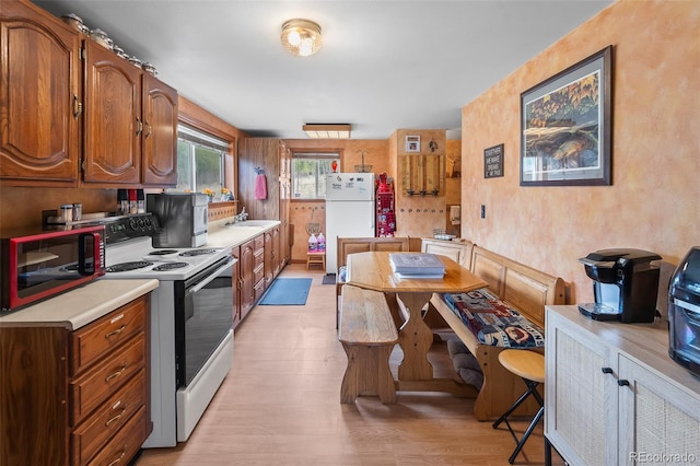 584 Old Squaw Rd, Como, CO 80432 - kitchen with electric stove, freestanding refrigerator, a sink, light wood finished floors, and light countertops