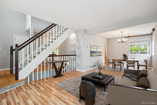 5721 S Jellison St, Littleton, CO 80123 - living room featuring wood finished floors, a chandelier, and stairway