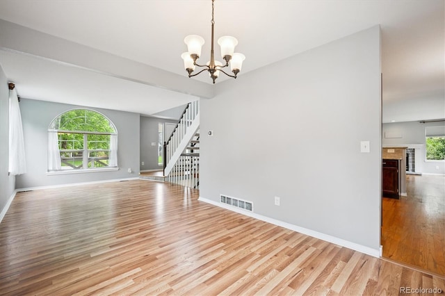 5721 S Jellison St, Littleton, CO 80123 - spare room featuring light wood-style floors, stairway, and a chandelier
