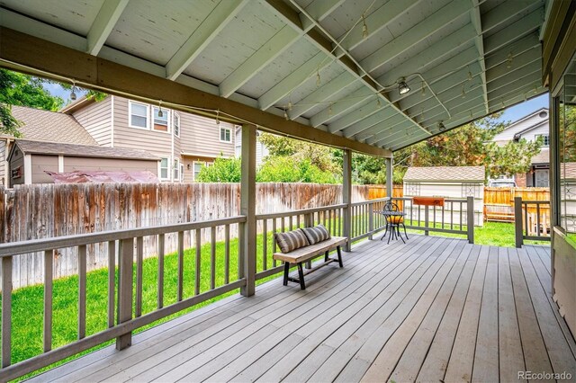 5721 S Jellison St, Littleton, CO 80123 - wooden deck featuring a fenced backyard and a storage unit