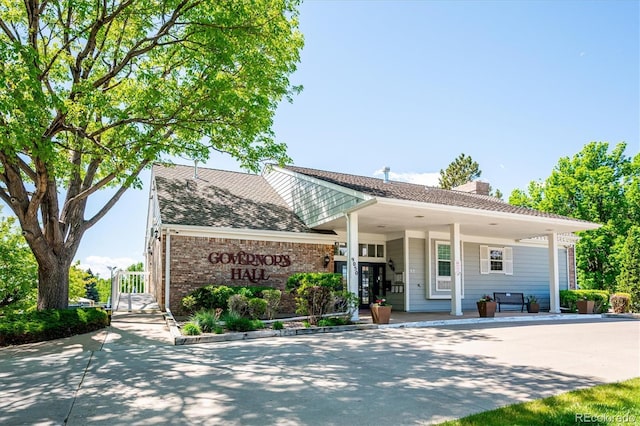 5721 S Jellison St, Littleton, CO 80123 - view of front of home featuring a chimney and brick siding