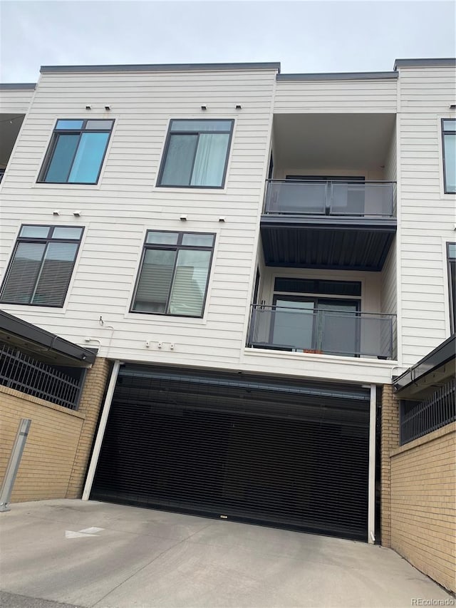 336 E 1st Ave Unit 310, Denver, CO 80203 - view of building exterior with a garage and concrete driveway