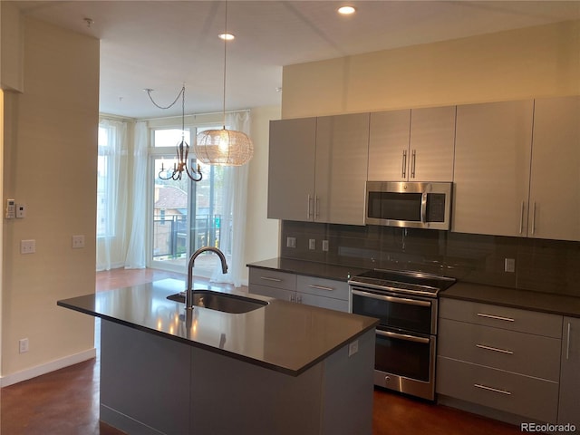 336 E 1st Ave Unit 310, Denver, CO 80203 - kitchen featuring appliances with stainless steel finishes, a sink, dark countertops, decorative backsplash, and recessed lighting
