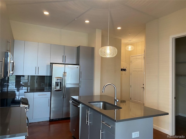 336 E 1st Ave Unit 310, Denver, CO 80203 - kitchen featuring a sink, appliances with stainless steel finishes, dark countertops, recessed lighting, and a center island with sink