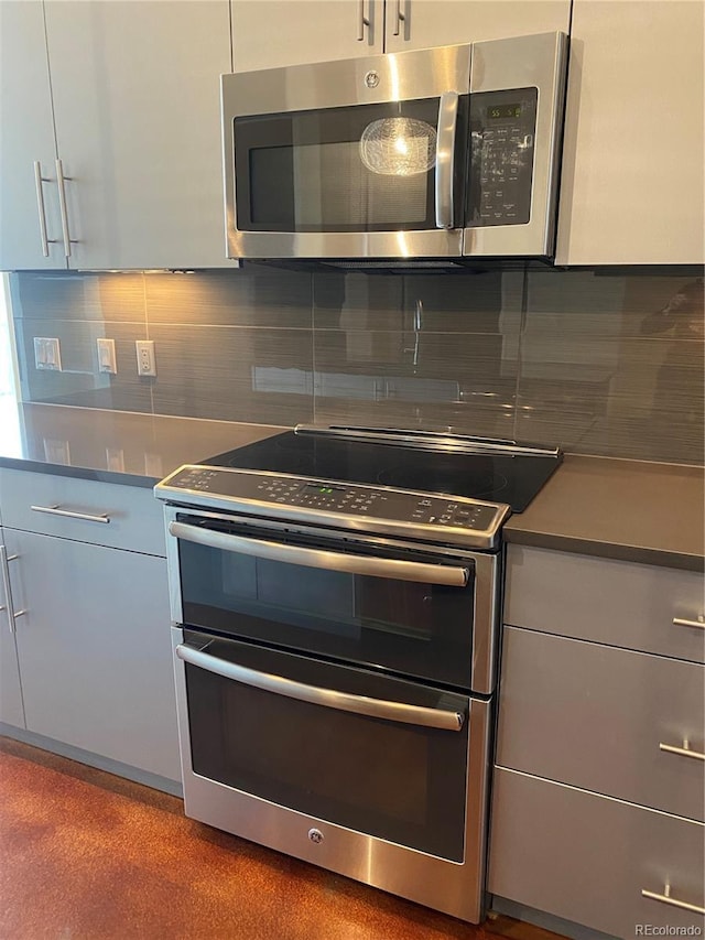 336 E 1st Ave Unit 310, Denver, CO 80203 - kitchen with appliances with stainless steel finishes and decorative backsplash