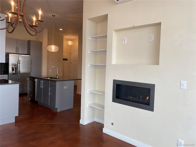 336 E 1st Ave Unit 310, Denver, CO 80203 - kitchen with built in shelves, dark countertops, finished concrete flooring, and appliances with stainless steel finishes