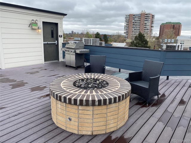 336 E 1st Ave Unit 310, Denver, CO 80203 - wooden deck featuring a fire pit and area for grilling