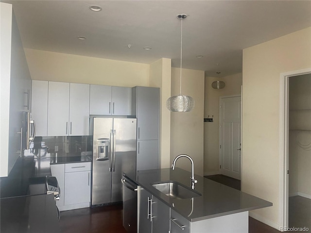 336 E 1st Ave Unit 310, Denver, CO 80203 - kitchen with a sink, stainless steel appliances, dark countertops, a center island with sink, and recessed lighting