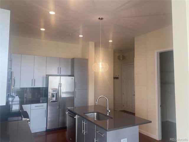 336 E 1st Ave Unit 310, Denver, CO 80203 - kitchen featuring a sink, appliances with stainless steel finishes, dark countertops, an island with sink, and recessed lighting