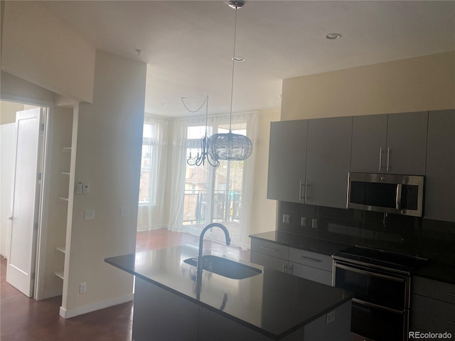 336 E 1st Ave Unit 310, Denver, CO 80203 - kitchen with stainless steel microwave, a sink, gray cabinets, an island with sink, and backsplash