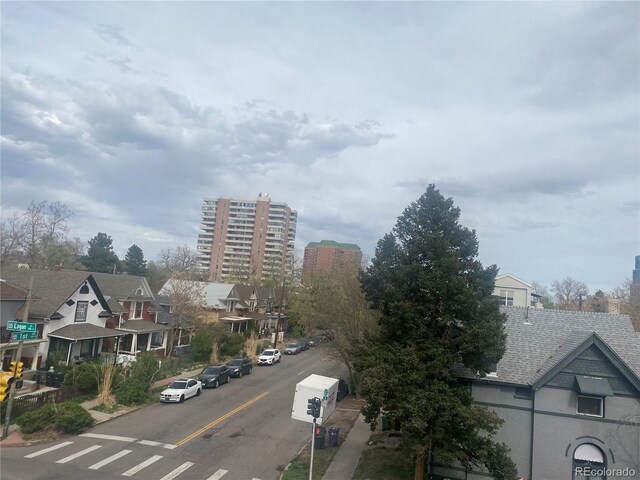 336 E 1st Ave Unit 310, Denver, CO 80203 - view of asphalt road with sidewalks, a residential view, and traffic signs