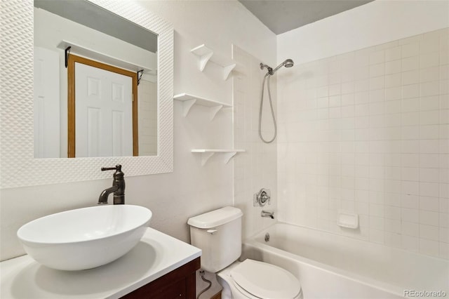 full bathroom featuring toilet, vanity, and tiled shower / bath