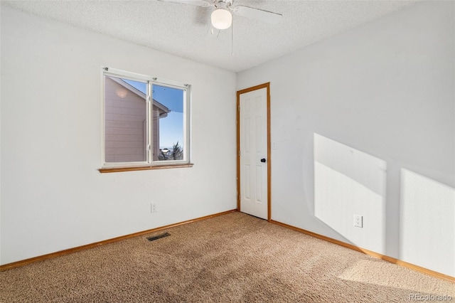 unfurnished room with ceiling fan, carpet, and a textured ceiling