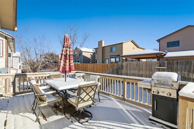 snow covered patio with a deck