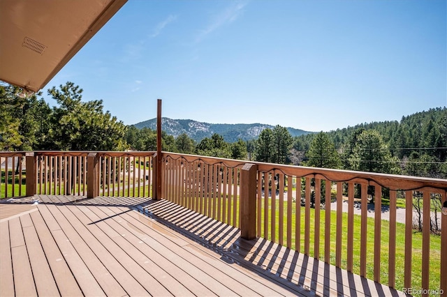 8045 S Wagon Wheel Rd, Morrison, CO 80465 - deck featuring a mountain view, a yard, and a forest view