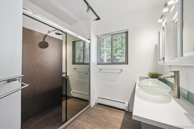 8045 S Wagon Wheel Rd, Morrison, CO 80465 - full bath featuring a baseboard radiator, a stall shower, and wood finished floors