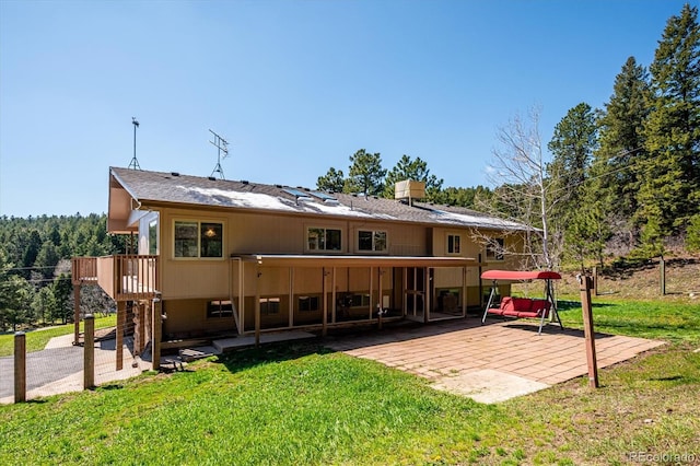 8045 S Wagon Wheel Rd, Morrison, CO 80465 - rear view of house featuring a patio, a yard, and a wooden deck