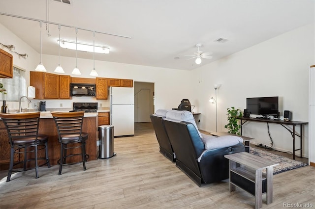 8045 S Wagon Wheel Rd, Morrison, CO 80465 - living room with light wood-style floors and a ceiling fan