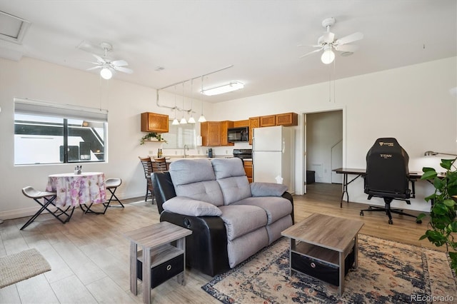 8045 S Wagon Wheel Rd, Morrison, CO 80465 - living area featuring a ceiling fan, light wood-type flooring, and baseboards