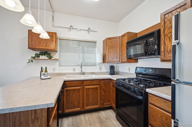 8045 S Wagon Wheel Rd, Morrison, CO 80465 - kitchen featuring black appliances, a sink, light countertops, light wood-style flooring, and brown cabinets