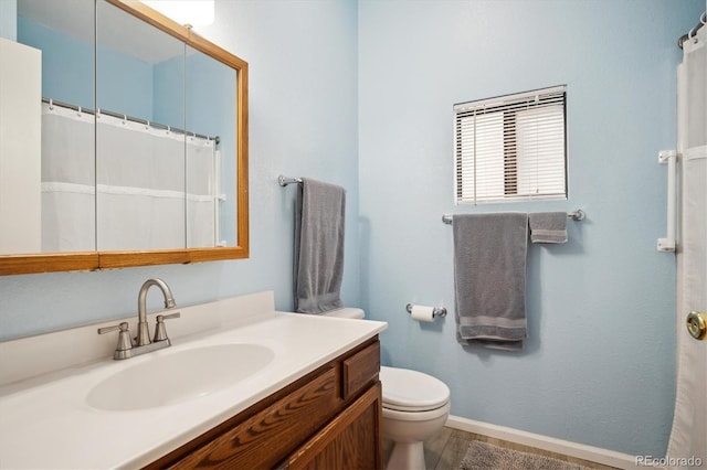 8045 S Wagon Wheel Rd, Morrison, CO 80465 - bathroom with baseboards, vanity, and toilet