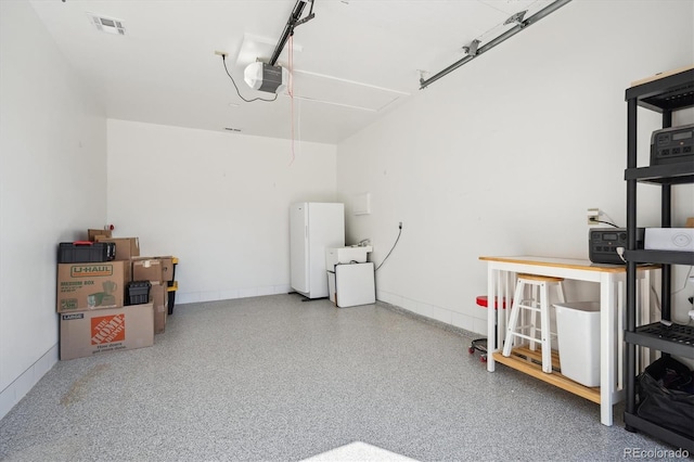 8045 S Wagon Wheel Rd, Morrison, CO 80465 - garage featuring a garage door opener and freestanding refrigerator